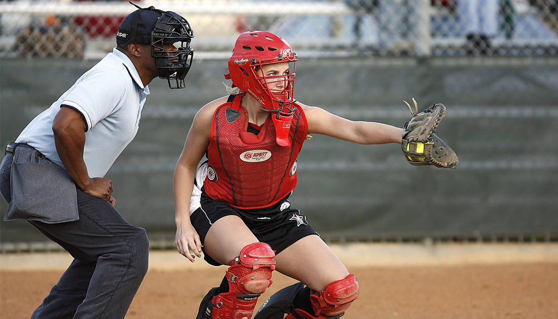 Fastpitch catcher catching a softball